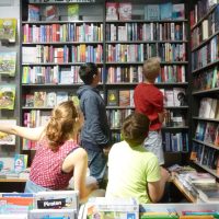Junge Leser beim Stöbern im Bücherregal